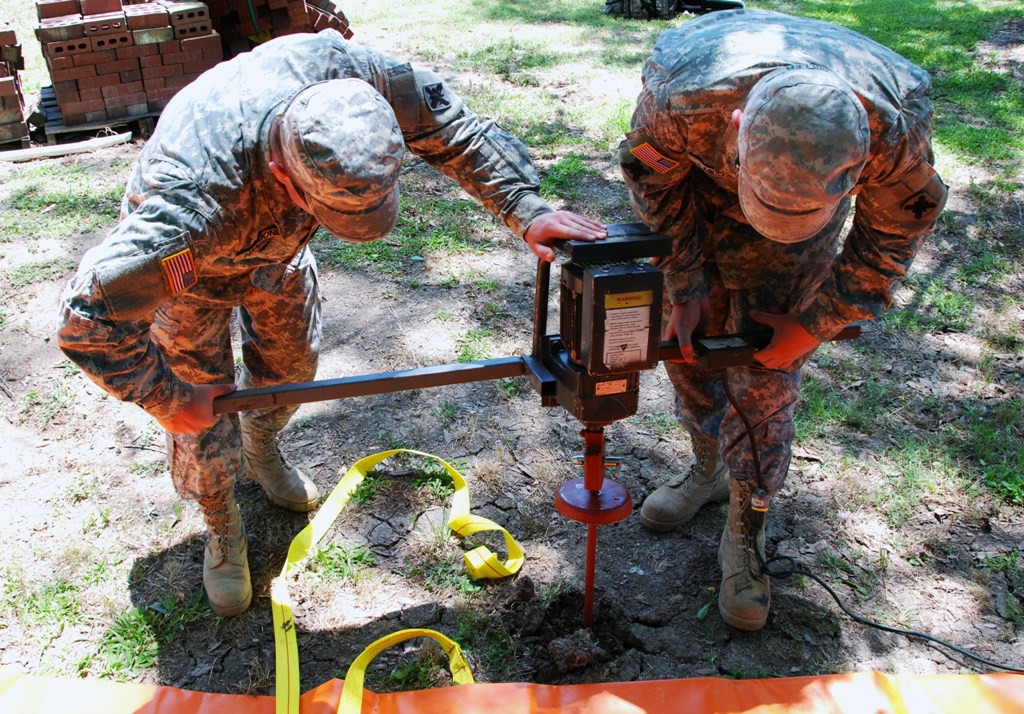 PIERRE PART, La. -- Louisiana National Guard Soldiers Pvt. Paris Hammond of Hammond, La., and Spc. Scylar Miller of Lafayette, La., work to assemble Tiger Dams to help prevent backwater flooding in Pierre Part, La., May 14, 2011. (U.S. Army photo by 2nd Lt. Mark J. Deshotels, 241st Mobile Public Affairs Detachment/Released)