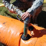 BAYOU LOURSE, La.  A Soldier with the 256th Brigade Special Troops Battalion pumps water into a Tiger Dam water-diversion system as the Louisiana National Guard heightens levees in response to possible backwater flooding from the opening of the Morganza Spillway in Bayou Lourse, La., May 17, 2011. (U.S. Army photo by Spc. Tarell J. Bilbo, 241st Mobile Public Affairs Detachment/Released)