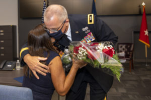 Maj. Gen. Keith Waddell, adjutant general of the Louisiana National Guard, hugs his wife, Lisa, as he gives her a bouquet of red roses in appreciation for her unwavering support during his promotion ceremony in the Governor’s Office of Homeland Security and Emergency Preparedness on July 30, 2021, in Baton Rouge, La. Maj. Gen. Waddell is the father of three children and the grandfather of three. (U.S. Air National Guard photo by Master Sgt. Toby Valadie)