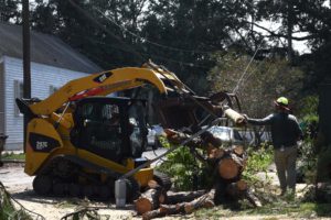 Members of the 202nd Rapid Engineer Deployable Heavy Operational Repair Squadron Engineers (Red Horse) partnered with the 159th Civil Engineering Squadron and New Orleans Parks and Parkways to clear debris from roadways in New Orleans, Sept. 4, 2021. Red Horse, from Camp Blanding, Fla., is a specialized, highly mobile civil engineering team comprised of Florida Army and Air National Guardsmen that provides rapid response capabilities for multiple worldwide contingencies and operations. (U.S. Air Force photo by Capt. Larissa Lambert)