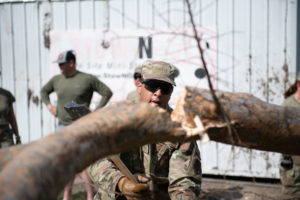 Senior Airman Tyrone Merritt of the 149th Fighter Wing Texas Air National Guard helps cut up a tree in Raceland, La., during Hurricane Ida response 7, Sept. 2021.  (Air National Guard photo by TSgt. Agustin G. Salazar)